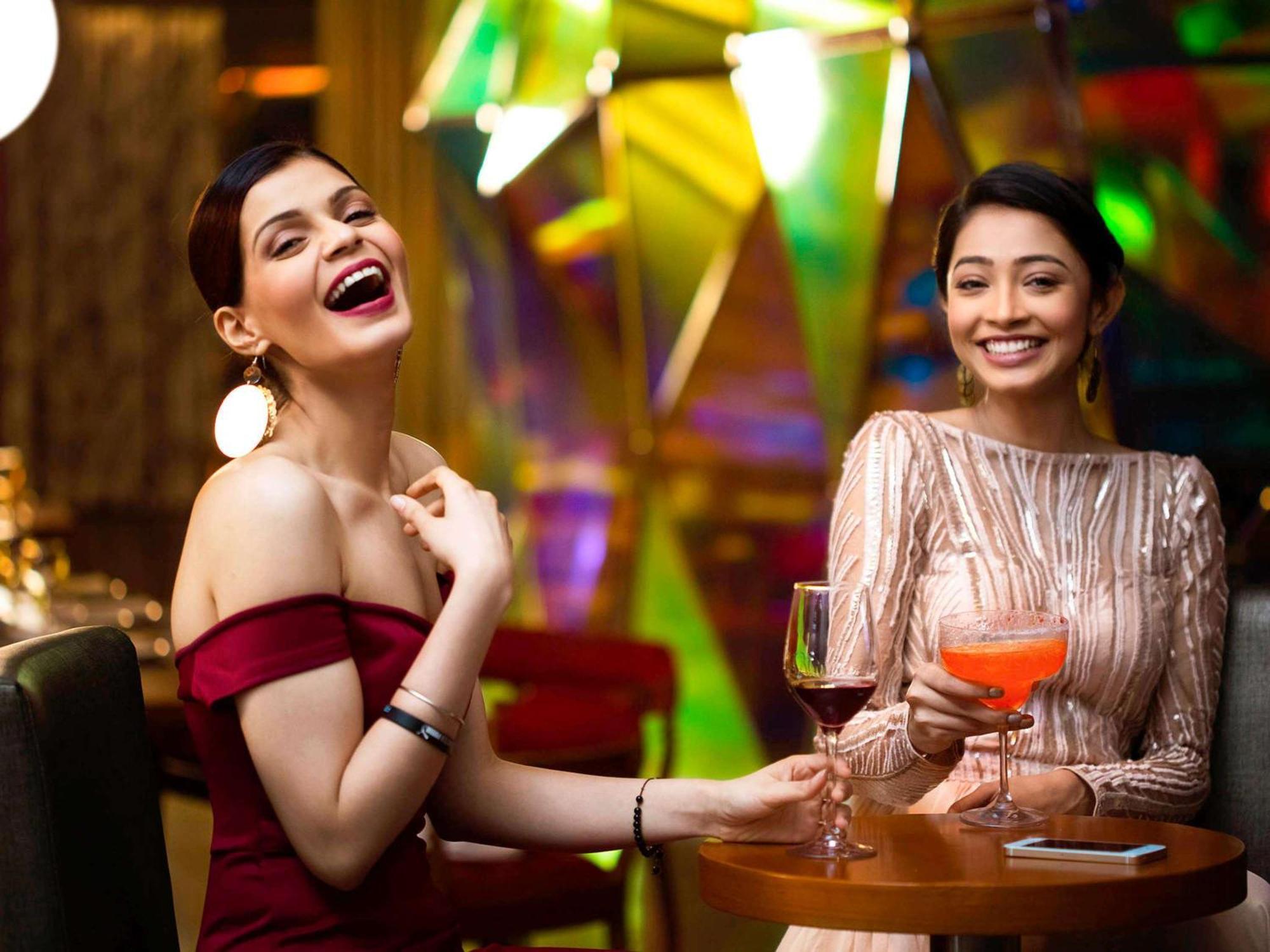 Novotel Kolkata Hotel&Residences Buitenkant foto Two women socializing